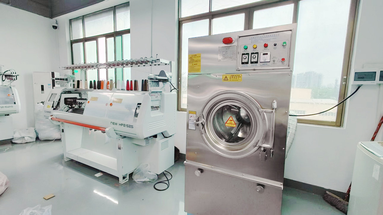 Computerized flat knitting machines row in JmSweater factory floor