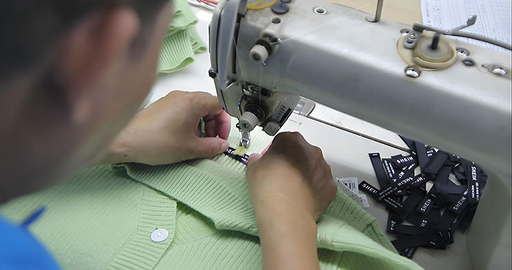 Custom brand label stitching by knitwear manufacturer