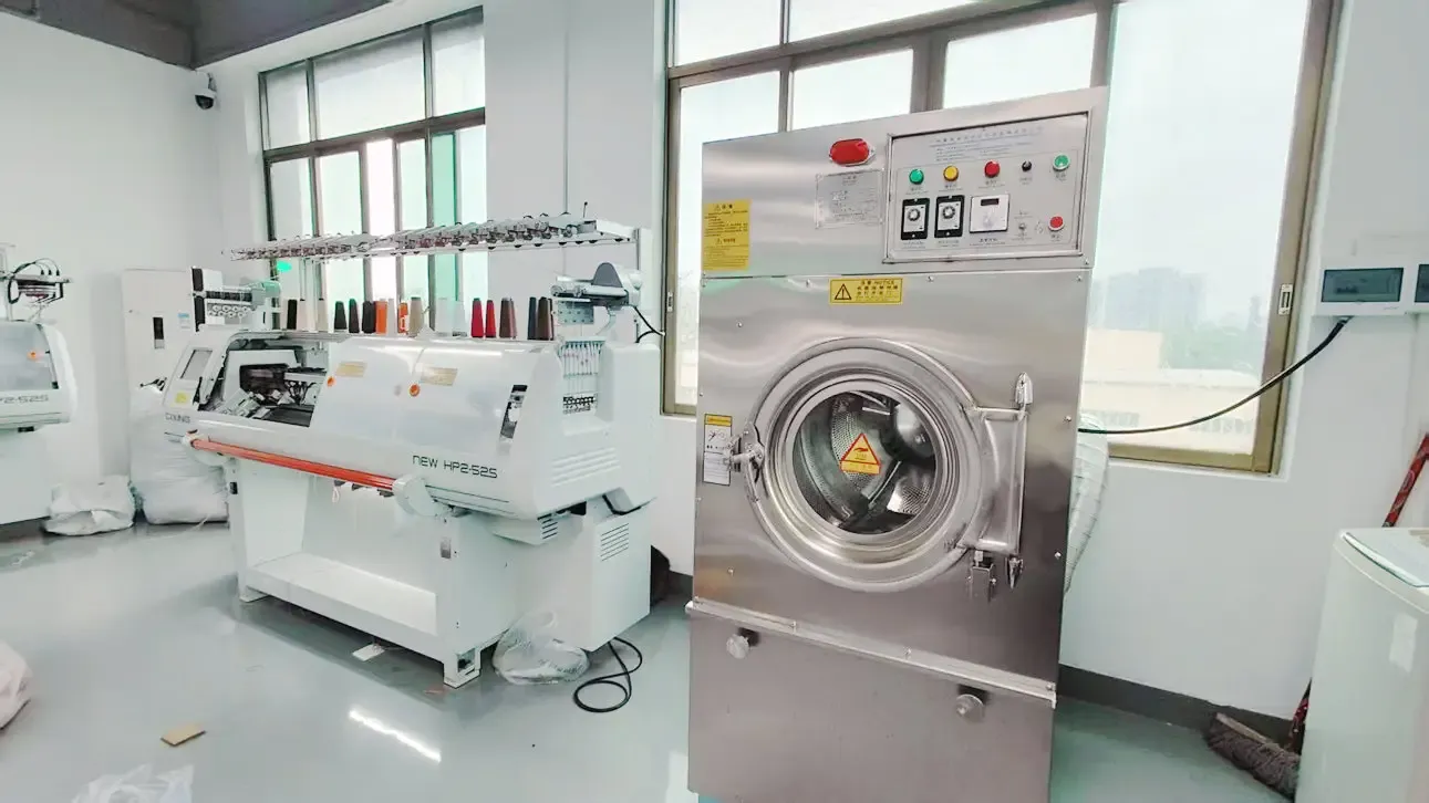 Computerized flat knitting machines row in JmSweater factory floor