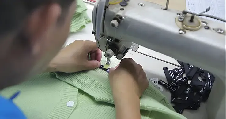 Custom brand label stitching by knitwear manufacturer