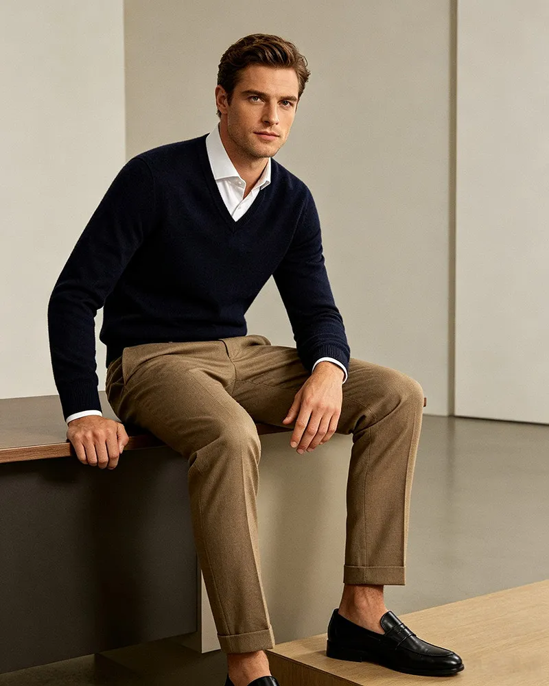 Men's navy V-neck sweater with white shirt and khakis