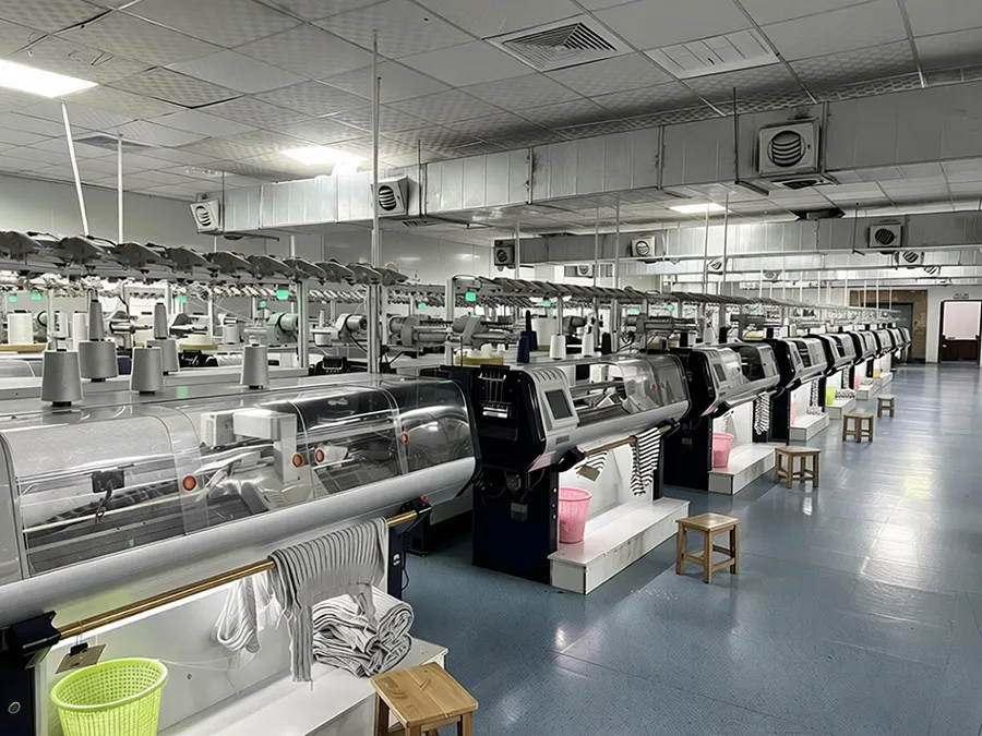 automated-computerized-flat-knitting-machines-row-inside-guangzhou-junma-apparel-factory-workshop-showing-oem-sweater-manufacturing-capacity