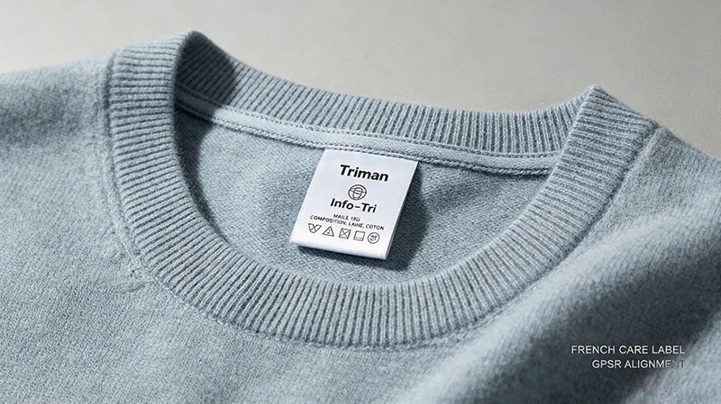 French compliance care label with Triman sorting mark sewn onto knitwear side seam