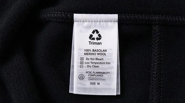 Garment care label featuring French Triman marking and FTC compliant fiber content
